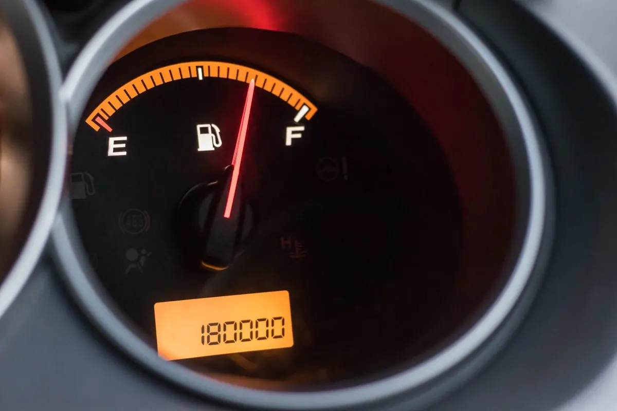 Close-up of a Vespa's speedometer and full fuel gauge display