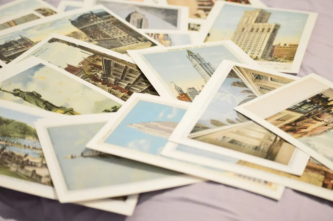 A scattered pile of vintage-style postcards